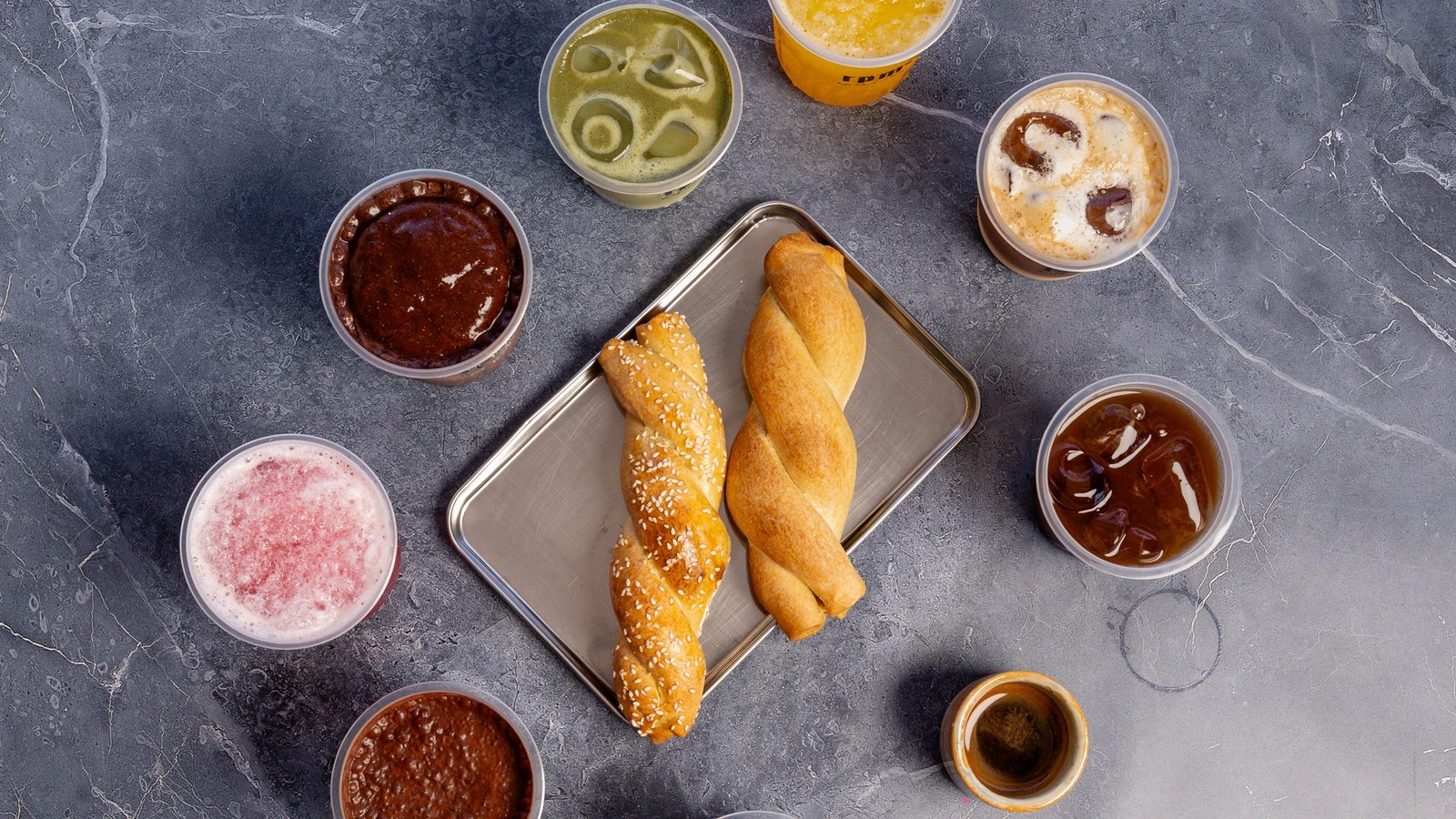 Iced coffees, matcha and fresh pastries from RPM on a slate table